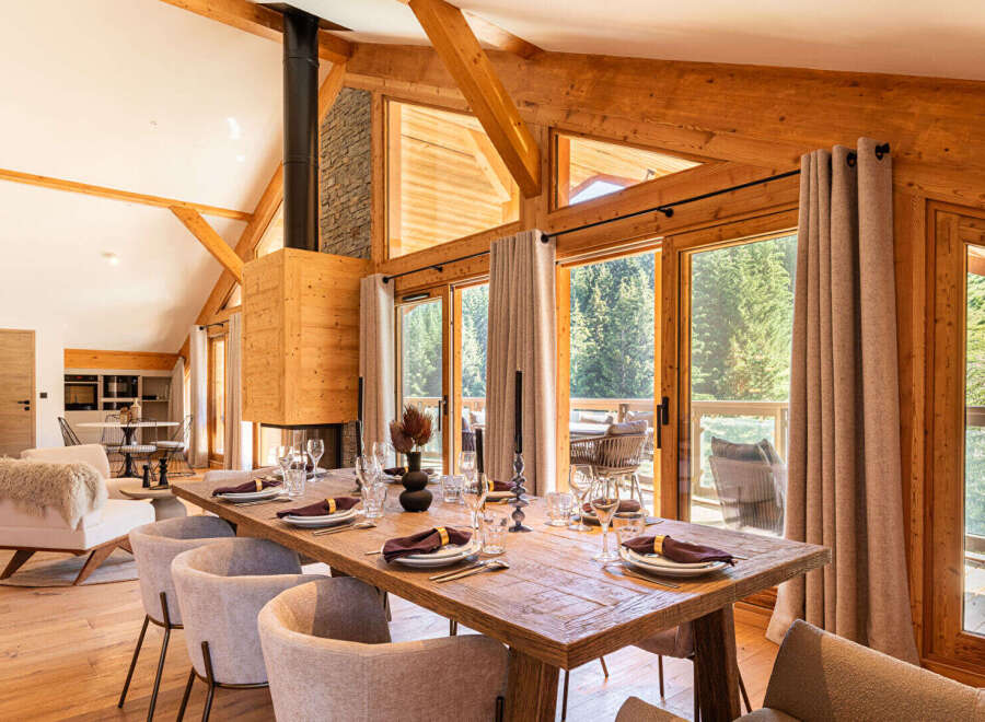 Experience luxury living in this stunning property featuring a spacious dining area with a rustic wooden table, perfect for hosting gatherings.