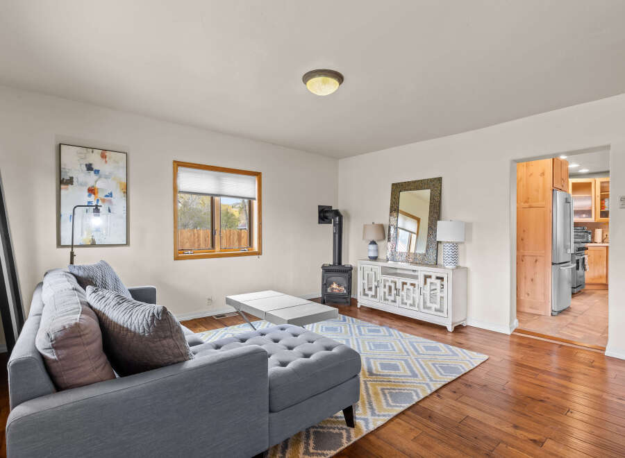 Step into this inviting living space, featuring a cozy fireplace and a stylish entertainment center.