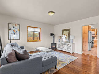 Step into this inviting living space, featuring a cozy fireplace and a stylish entertainment center.