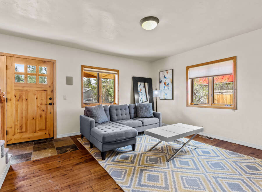 Step into this inviting living space, featuring a stylish gray sectional sofa and a modern coffee table.