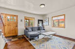 Step into this inviting living space, featuring a stylish gray sectional sofa and a modern coffee table.