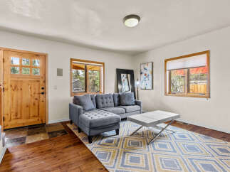 Step into this inviting living space, featuring a stylish gray sectional sofa and a modern coffee table.