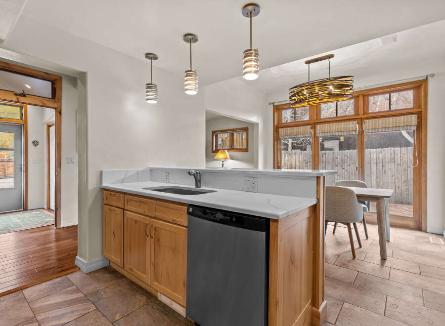 This stunning kitchen boasts a modern design with sleek countertops and ample cabinet space.