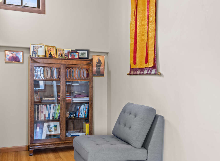 This cozy living space features a beautiful wooden bookcase filled with books and decorative items, perfect for displaying your personal library and collectibles.