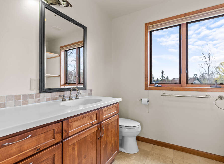 This beautiful bathroom features a stylish vanity with ample storage and a sleek countertop.