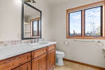 This beautiful bathroom features a stylish vanity with ample storage and a sleek countertop.