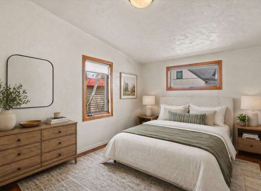 Step into this inviting bedroom, featuring a serene ambiance and stylish design.