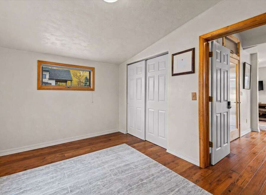 Discover the charm of this inviting room, featuring beautiful hardwood floors and a cozy rug.