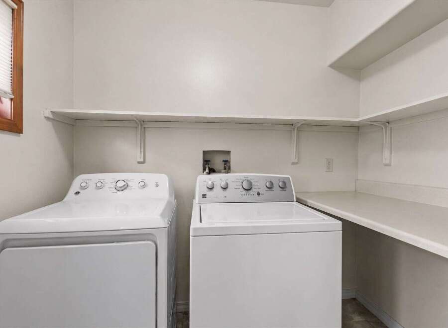 This laundry room features a modern design with a washer and dryer set.