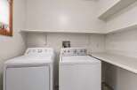 This laundry room features a modern design with a washer and dryer set.