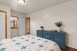 This charming bedroom features a beautiful blue dresser, adding a pop of color to the space.