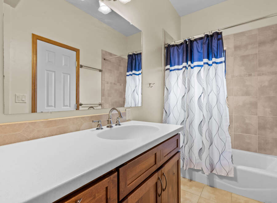 This bathroom features a bright and airy design with a modern vanity and a spacious countertop.