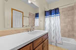 This bathroom features a bright and airy design with a modern vanity and a spacious countertop.