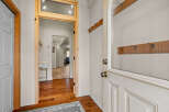 Step into this inviting entryway, showcasing beautiful hardwood floors and a glimpse of the home's interior.