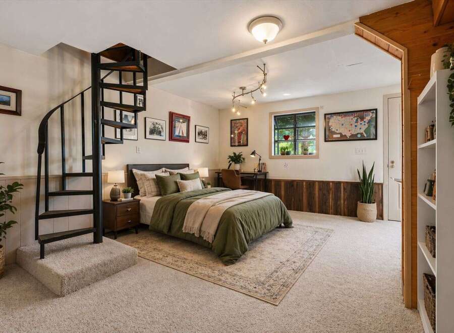 This cozy bedroom features a unique spiral staircase leading to an upper level, adding a touch of architectural interest.