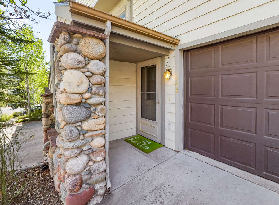 This charming property boasts a unique stone facade, creating a warm and inviting curb appeal.