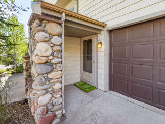 This charming property boasts a unique stone facade, creating a warm and inviting curb appeal.