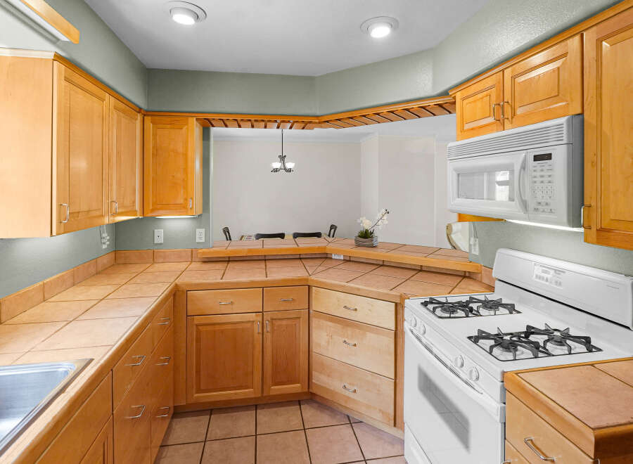 This stunning kitchen boasts beautiful wooden cabinetry, offering ample storage and a warm, inviting atmosphere.