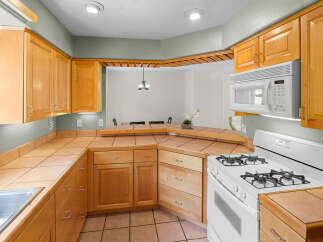 This stunning kitchen boasts beautiful wooden cabinetry, offering ample storage and a warm, inviting atmosphere.