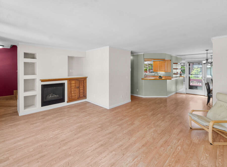 Step into this inviting living space, featuring a cozy fireplace and stylish built-in shelving.