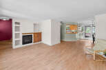Step into this inviting living space, featuring a cozy fireplace and stylish built-in shelving.