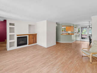 Step into this inviting living space, featuring a cozy fireplace and stylish built-in shelving.