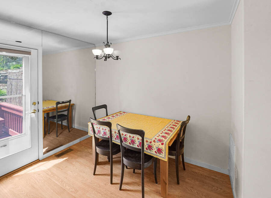 This charming dining area features a cozy table set for meals, perfect for intimate gatherings.