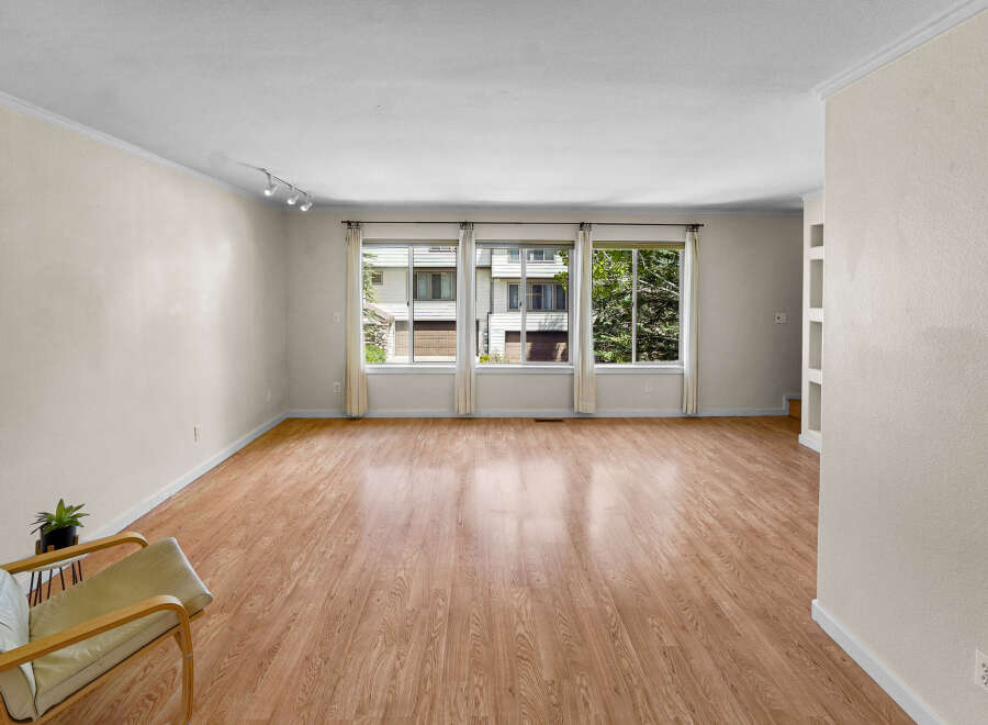 Step into this inviting living space, featuring beautiful hardwood floors and ample natural light streaming through large windows.