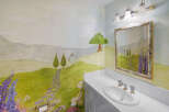 This charming bathroom features a whimsical mural, creating a serene and artistic atmosphere.