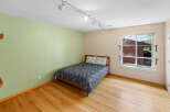 This inviting bedroom features a cozy bed with a stylish patterned duvet and pillows, perfect for a relaxing retreat.