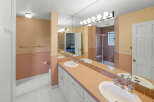This bathroom features a double vanity with ample counter space, perfect for getting ready in the morning.
