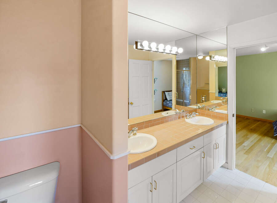 Step into this beautifully designed bathroom, featuring a stylish vanity with dual sinks and ample storage.