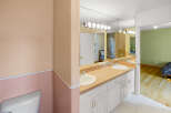 Step into this beautifully designed bathroom, featuring a stylish vanity with dual sinks and ample storage.