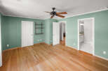 Step into this inviting bedroom, featuring beautiful hardwood floors and a fresh, modern aesthetic.