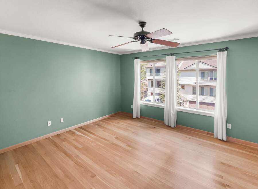 This inviting room features beautiful hardwood floors and a fresh, neutral paint color, creating a warm and welcoming atmosphere.