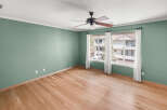 This inviting room features beautiful hardwood floors and a fresh, neutral paint color, creating a warm and welcoming atmosphere.
