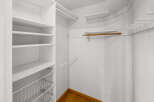 Step into this well-organized walk-in closet, offering ample storage space for your wardrobe.