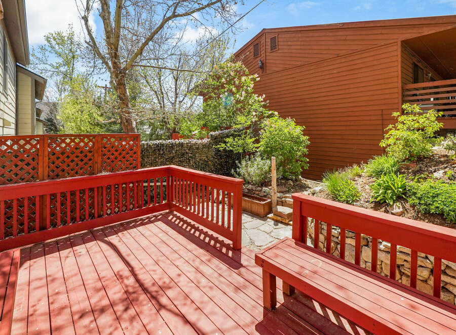 Enjoy outdoor living on this charming deck! This property features a beautifully designed deck with a vibrant red finish, perfect for entertaining or relaxing.