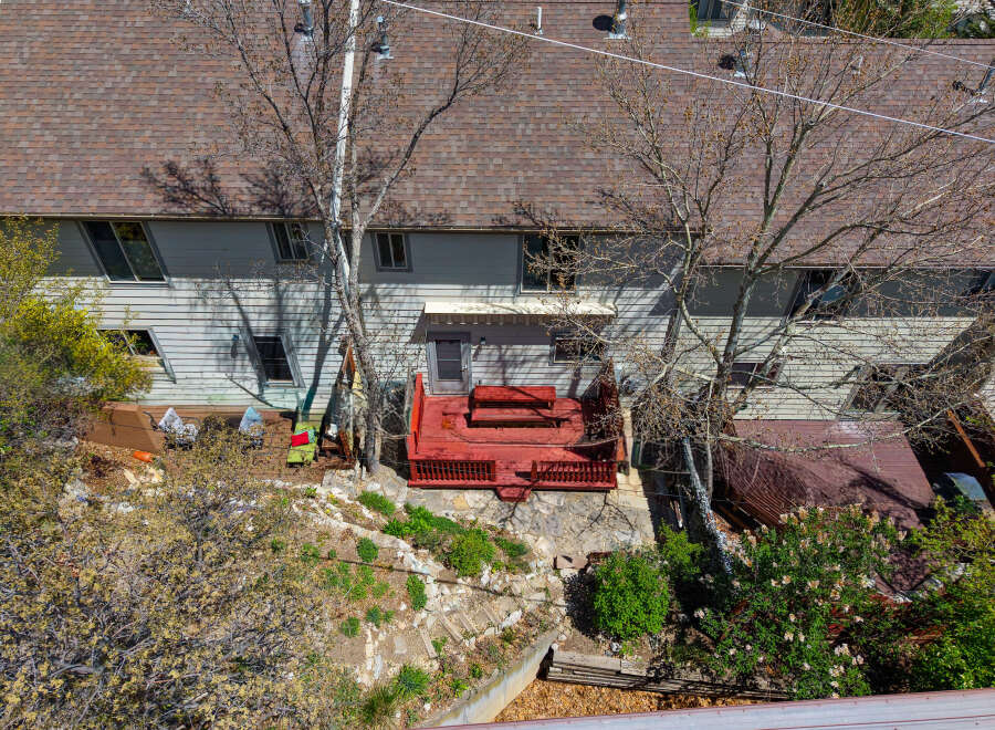 Discover this charming property featuring a vibrant red deck, perfect for outdoor gatherings.