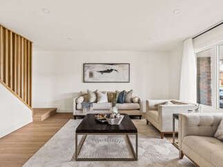 Step into this inviting living space, showcasing a blend of modern design and cozy comfort.