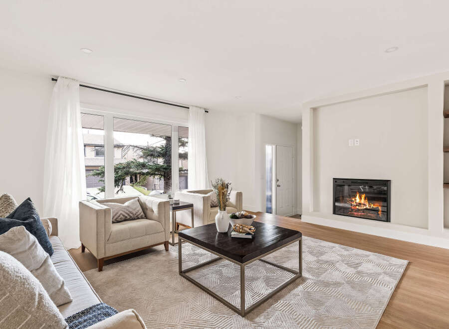 Step into luxury with this stunning living room, featuring a cozy fireplace and elegant design.