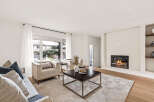 Step into luxury with this stunning living room, featuring a cozy fireplace and elegant design.
