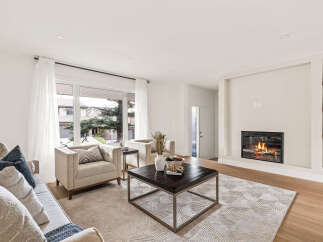 Step into luxury with this stunning living room, featuring a cozy fireplace and elegant design.