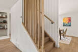 This stunning property boasts a modern staircase with a natural wood design, creating a warm and inviting atmosphere.