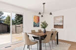 This stunning dining room features a modern aesthetic with a beautiful wooden dining table and stylish chairs.