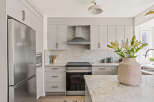 This stunning kitchen boasts a modern design with sleek cabinetry and stainless steel appliances.