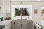 This stunning kitchen boasts a modern design with sleek cabinetry and elegant countertops.