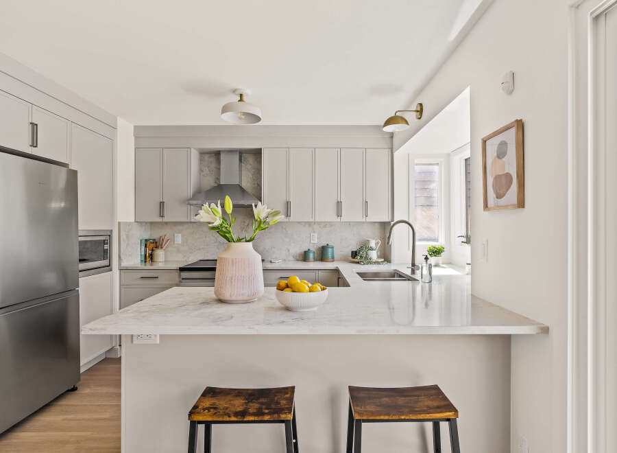 This stunning kitchen boasts a modern design with sleek cabinetry and a spacious island, perfect for both cooking and entertaining.