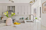 This stunning kitchen boasts a modern design with sleek cabinetry and a beautiful marble countertop.