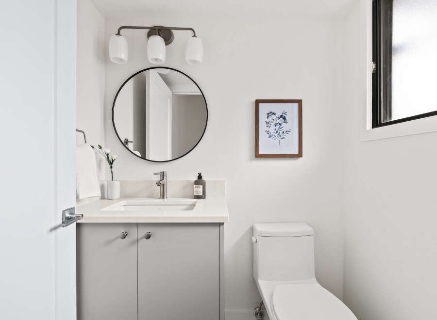 Step into this beautifully designed bathroom, featuring a modern vanity with ample storage and a sleek countertop.